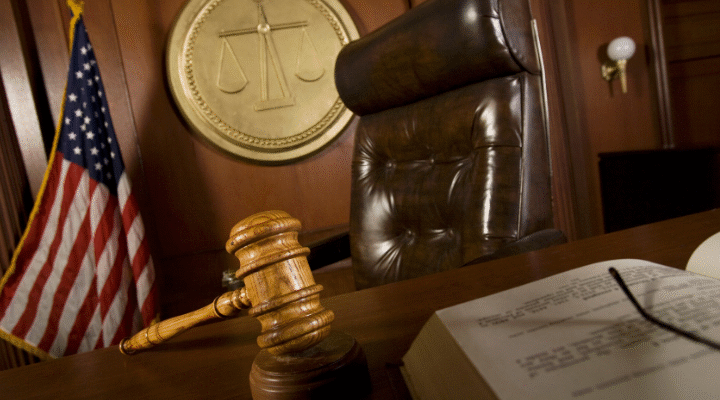 Courtroom scene featuring a judge's gavel and a book, highlighting Nevada DUI School and Victim Impact Panel requirements.
